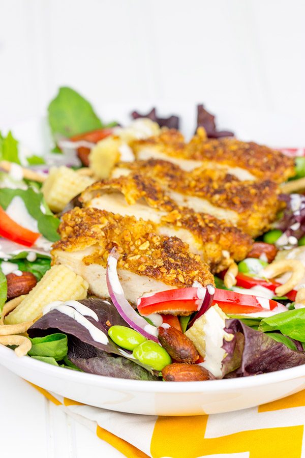 Topped with sriracha almond-encrusted chicken and a sriracha ranch dressing, this Sriracha Almond Chicken Salad makes for a tasty summer lunch!