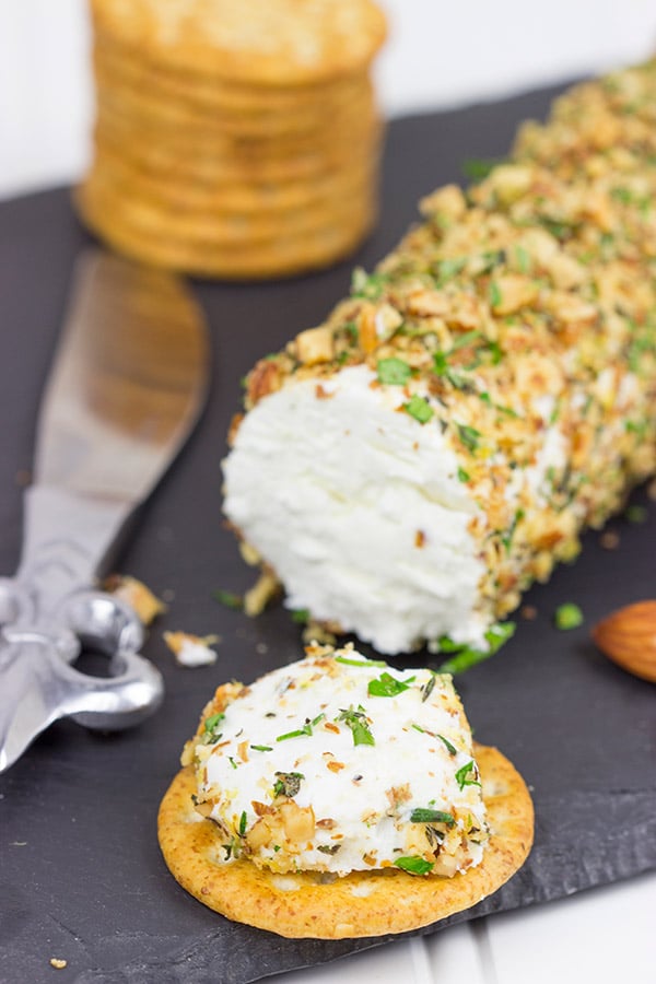 Rolled in chopped almonds and fresh herbs, this Almond Herb Goat Cheese makes for a quick and tasty summer snack!