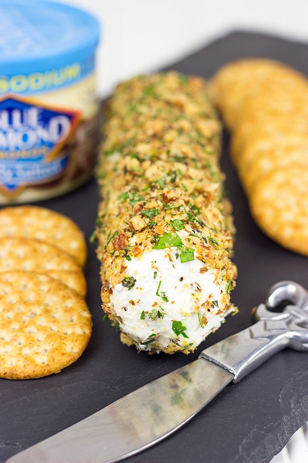 Rolled in chopped almonds and fresh herbs, this Almond Herb Goat Cheese makes for a quick and tasty summer snack!