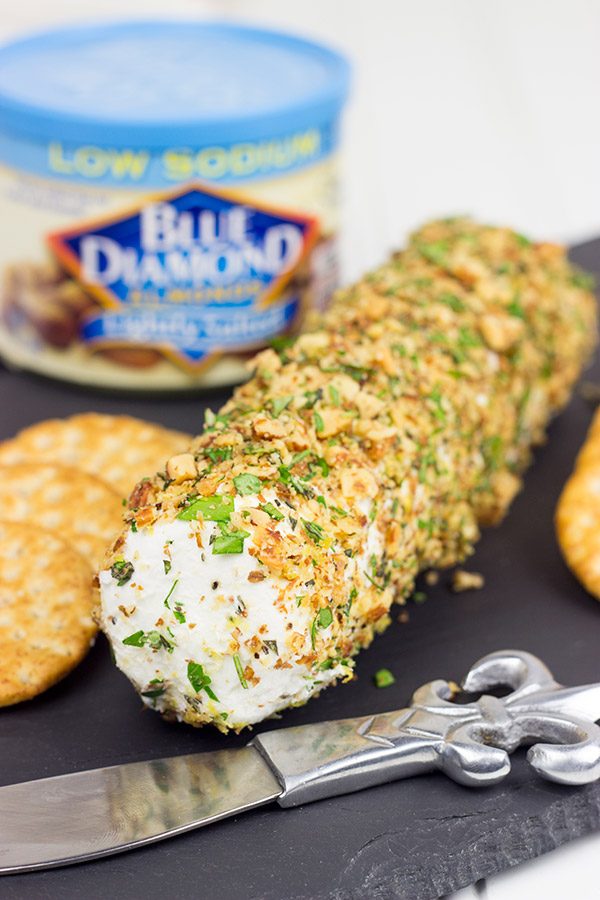 Rolled in chopped almonds and fresh herbs, this Almond Herb Goat Cheese makes for a quick and tasty summer snack!