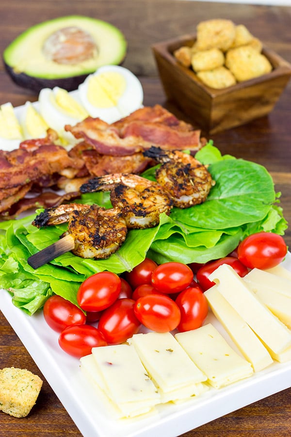 Topped with grilled Cajun shrimp, this Cajun Shrimp Chef Salad makes for one heck of a delicious summer meal!