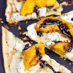 Grab some fresh peaches and toss 'em on the grill! This Grilled Peach and Ricotta Flatbread makes for one awesome summer meal!