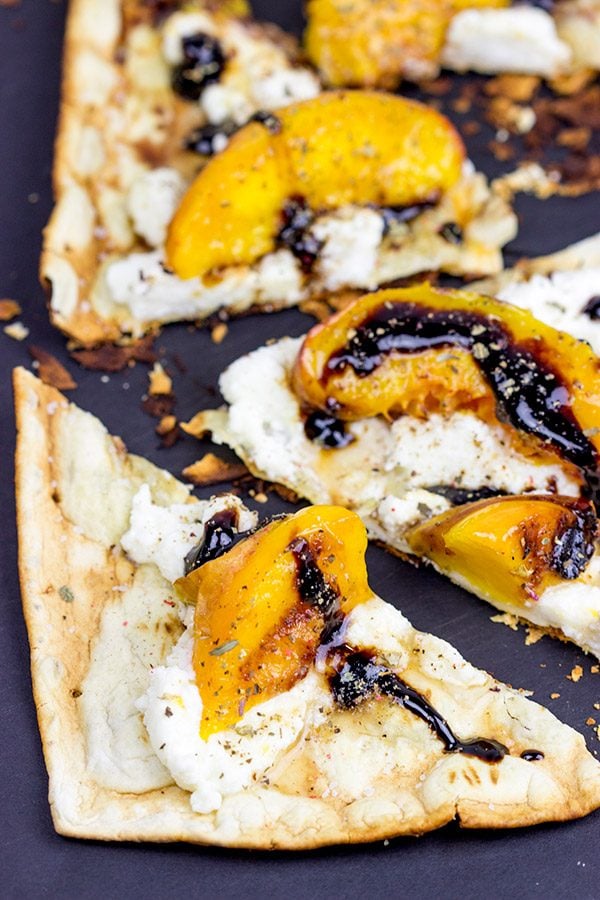 Grab some fresh peaches and toss 'em on the grill! This Grilled Peach and Ricotta Flatbread makes for one awesome summer meal!