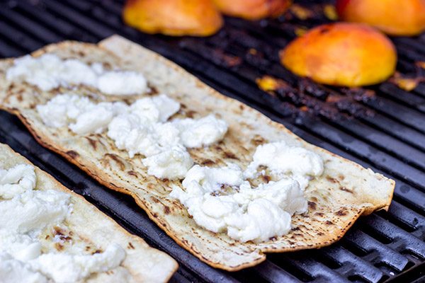 Grab some fresh peaches and toss 'em on the grill! This Grilled Peach and Ricotta Flatbread makes for one awesome summer meal!