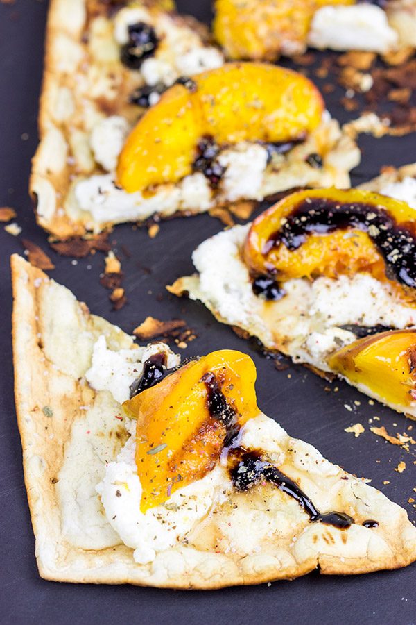 Grab some fresh peaches and toss 'em on the grill! This Grilled Peach and Ricotta Flatbread makes for one awesome summer meal!
