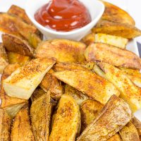 Serve these delicious Oven Roasted Potato Wedges with a quick and easy Smoky Ketchup. I dare you to just eat one!