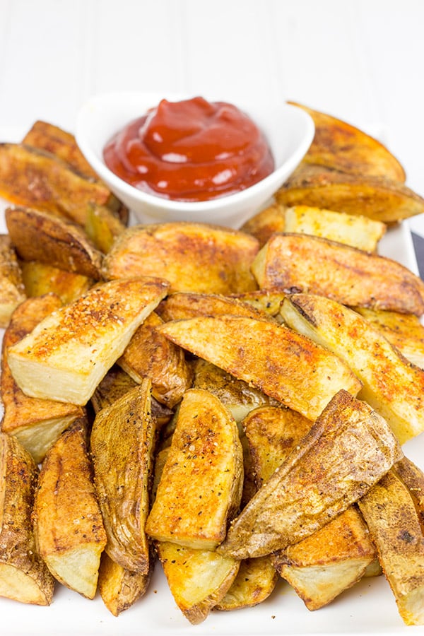 Serve these delicious Oven Roasted Potato Wedges with a quick and easy Smoky Ketchup. I dare you to just eat one!