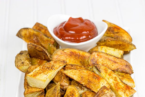Serve these delicious Oven Roasted Potato Wedges with a quick and easy Smoky Ketchup. I dare you to just eat one!