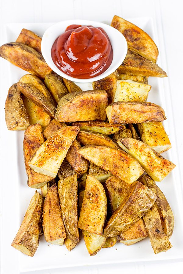 Serve these delicious Oven Roasted Potato Wedges with a quick and easy Smoky Ketchup. I dare you to just eat one!