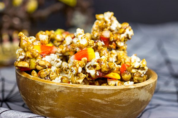 Grab some extra candy corn and whip up a batch of this tasty Halloween Caramel Corn!