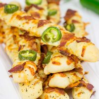 Topped with bacon, jalapenos and two types of cheese, these Bacon Jalapeno Cheesy Breadsticks are an easy and delicious gametime snack!
