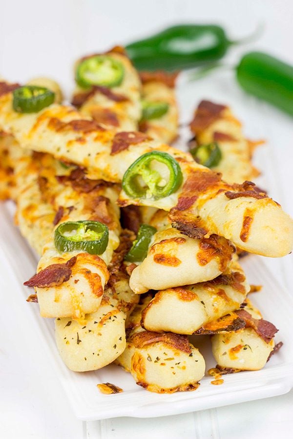 Topped with bacon, jalapenos and two types of cheese, these Bacon Jalapeno Cheesy Breadsticks are an easy and delicious gametime snack!