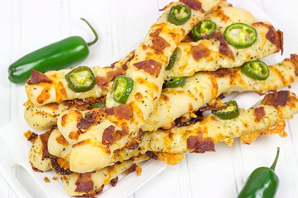 Topped with bacon, jalapenos and two types of cheese, these Bacon Jalapeno Cheesy Breadsticks are an easy and delicious gametime snack!