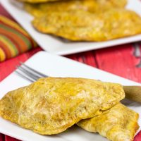 Shredded chicken + cheese + spices all wrapped up in a flaky shell--you can't go wrong with these tasty Cheesy Chicken Empanadas!