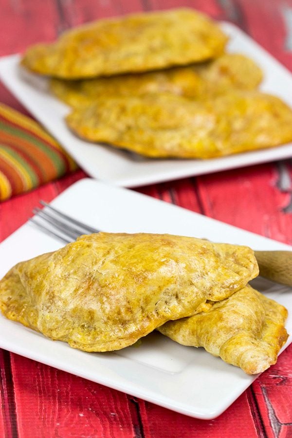 Shredded chicken + cheese + spices all wrapped up in a flaky shell--you can't go wrong with these tasty Cheesy Chicken Empanadas!
