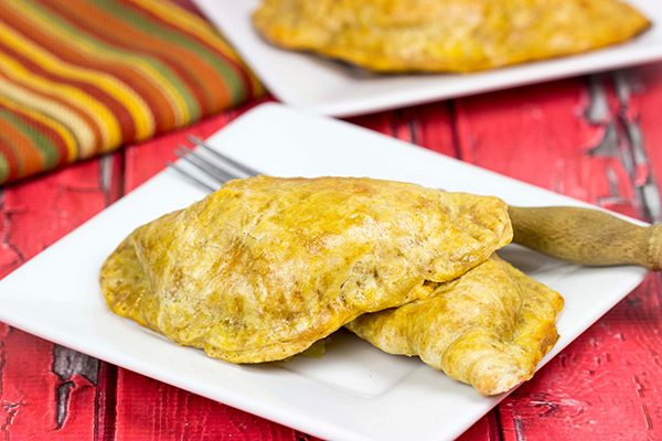 Shredded chicken + cheese + spices all wrapped up in a flaky shell--you can't go wrong with these tasty Cheesy Chicken Empanadas!