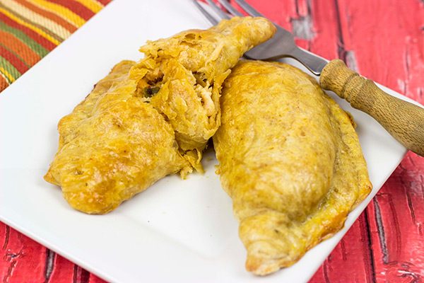 Shredded chicken + cheese + spices all wrapped up in a flaky shell--you can't go wrong with these tasty Cheesy Chicken Empanadas!