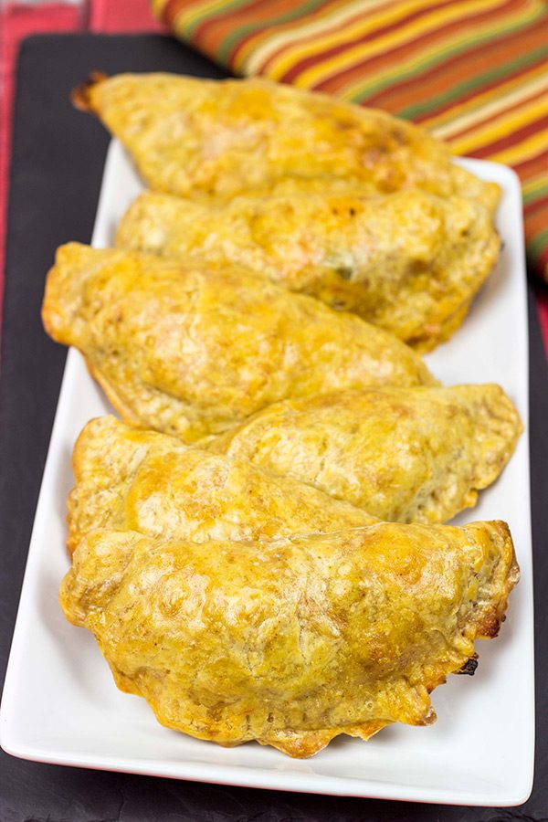 Shredded chicken + cheese + spices all wrapped up in a flaky shell--you can't go wrong with these tasty Cheesy Chicken Empanadas!