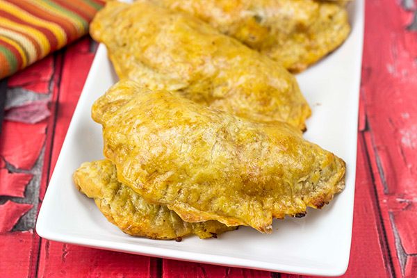 Shredded chicken + cheese + spices all wrapped up in a flaky shell--you can't go wrong with these tasty Cheesy Chicken Empanadas!