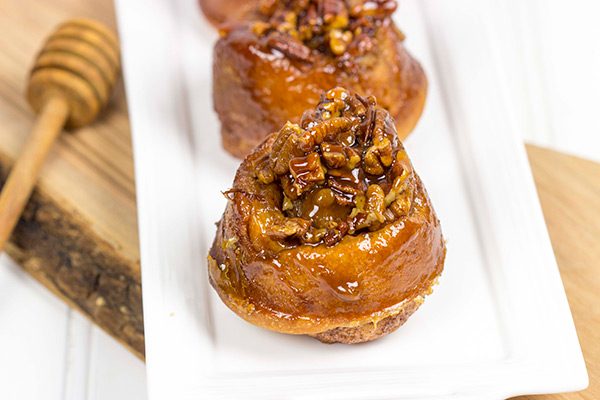 Topped with a delicious gooey honey pecan mixture, these Honey Pecan Sticky Buns will magically disappear from your kitchen!