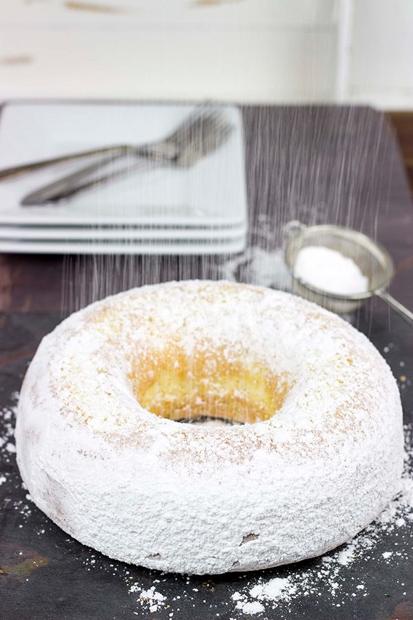 This Powdered Sugar Doughnut Cake is a throwback to Saturday morning cartoons and powdered sugar doughnuts!