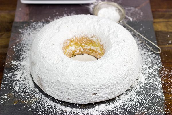 This Powdered Sugar Doughnut Cake is a throwback to Saturday morning cartoons and powdered sugar doughnuts!