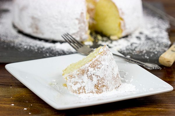 This Powdered Sugar Doughnut Cake is a throwback to Saturday morning cartoons and powdered sugar doughnuts!