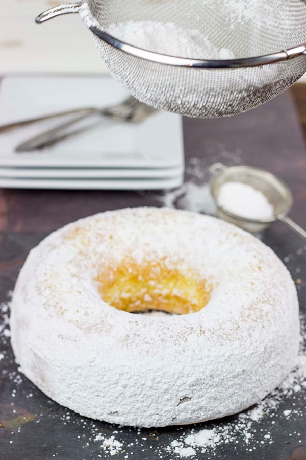 This Powdered Sugar Doughnut Cake is a throwback to Saturday morning cartoons and powdered sugar doughnuts!