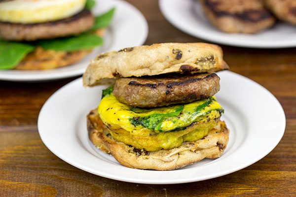 Making breakfast for a crowd?  Kitchen hack: Bake eggs in muffin tins to save time!  These Sausage and Egg Muffin Sandwiches are a favorite around our house!