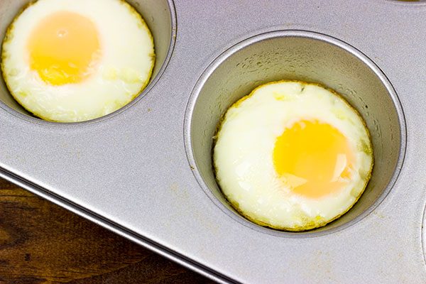 Making breakfast for a crowd?  Kitchen hack: Bake eggs in muffin tins to save time!  These Sausage and Egg Muffin Sandwiches are a favorite around our house!