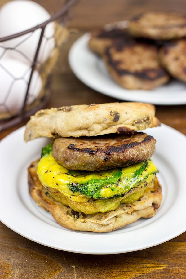 Making breakfast for a crowd?  Kitchen hack: Bake eggs in muffin tins to save time!  These Sausage and Egg Muffin Sandwiches are a favorite around our house!