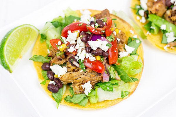 These Pulled Pork Tostadas are a quick and easy way to break out of the boring dinner routine!