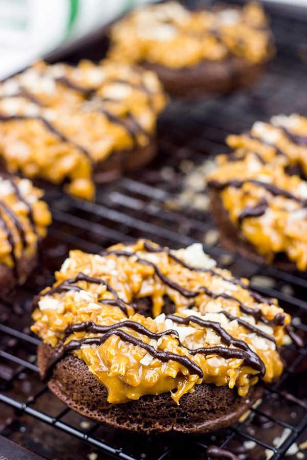 Chocolate doughnuts topped with caramel and coconut, these Baked Samoa Doughnuts will be a huge hit in your house!