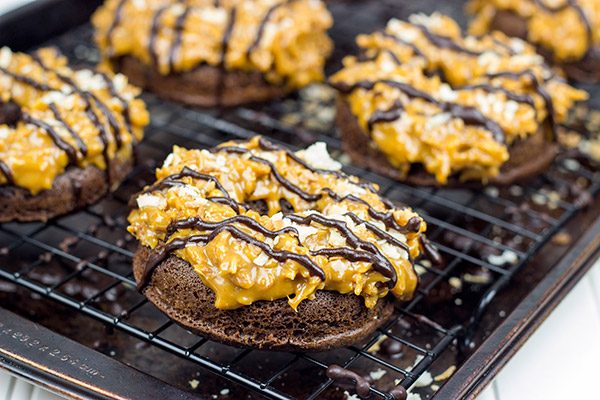 Chocolate doughnuts topped with caramel and coconut, these Baked Samoa Doughnuts will be a huge hit in your house!