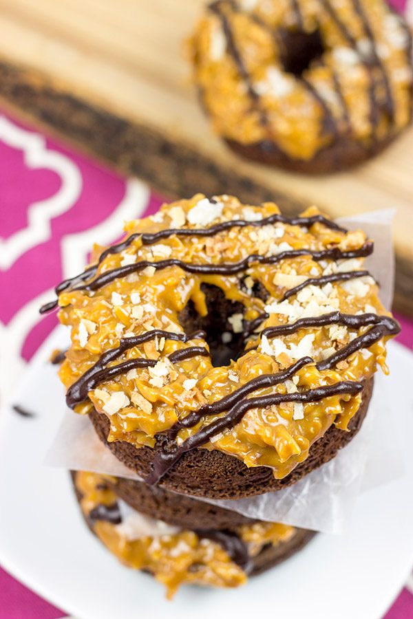 Chocolate doughnuts topped with caramel and coconut, these Baked Samoa Doughnuts will be a huge hit in your house!