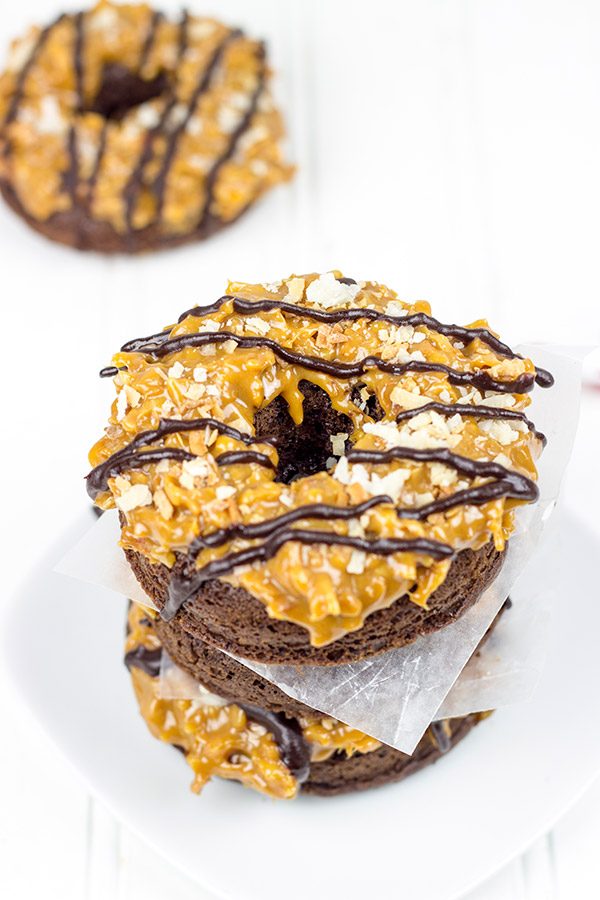 Chocolate doughnuts topped with caramel and coconut, these Baked Samoa Doughnuts will be a huge hit in your house!