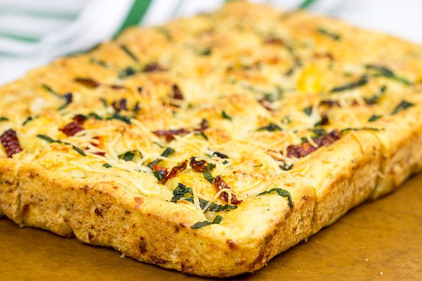 Need a unique and tasty appetizer? Give this Cheesy Spinach and Sundried Tomato Focaccia a try! (Just don't eat it all before the party...)