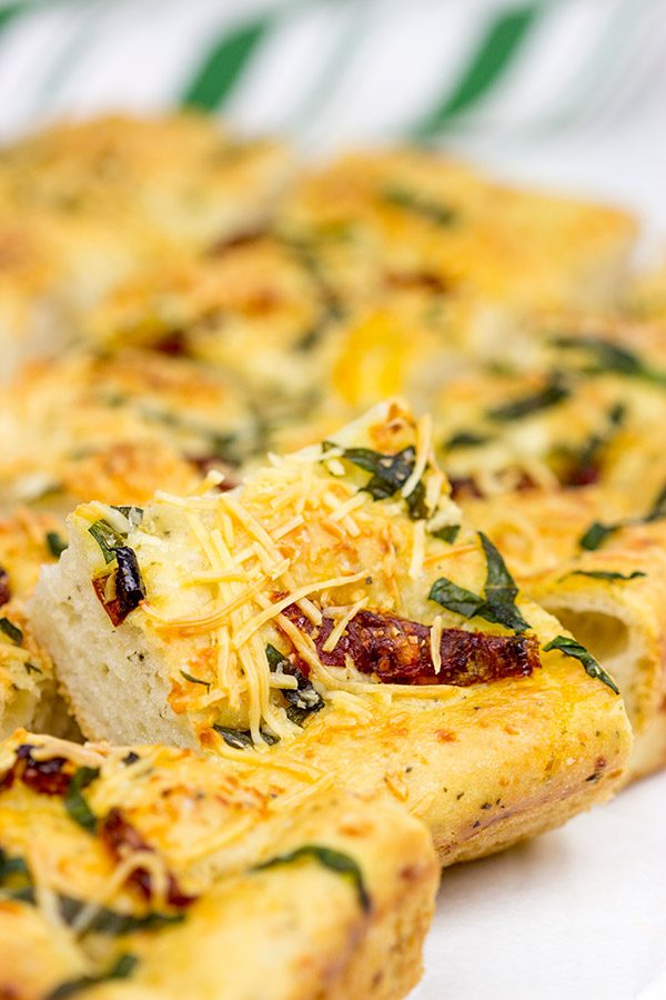 Need a unique and tasty appetizer? Give this Cheesy Spinach and Sundried Tomato Focaccia a try! (Just don't eat it all before the party...)