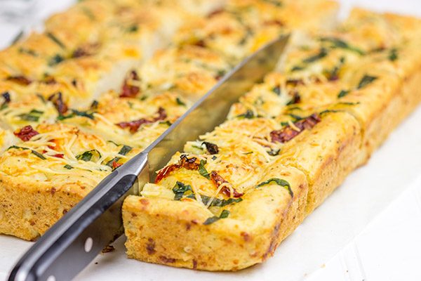 Need a unique and tasty appetizer? Give this Cheesy Spinach and Sundried Tomato Focaccia a try! (Just don't eat it all before the party...)