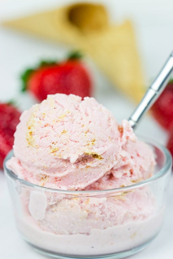 Fresh strawberries blended with cream cheese and yogurt, this Strawberry Cheesecake Frozen Yogurt is the perfect treat for summer evenings on the back porch!