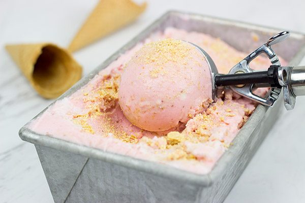 Fresh strawberries blended with cream cheese and yogurt, this Strawberry Cheesecake Frozen Yogurt is the perfect treat for summer evenings on the back porch!