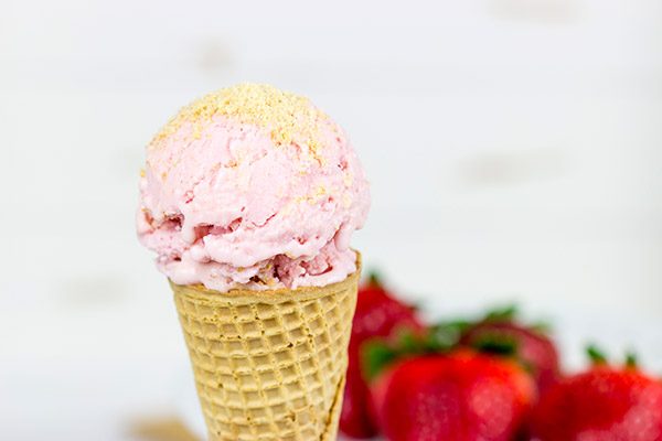 Fresh strawberries blended with cream cheese and yogurt, this Strawberry Cheesecake Frozen Yogurt is the perfect treat for summer evenings on the back porch!