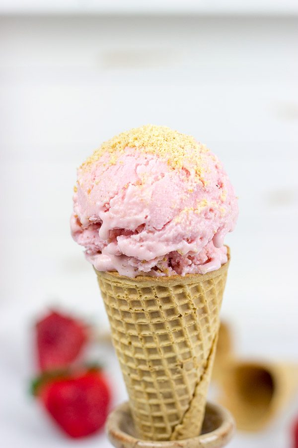 Fresh strawberries blended with cream cheese and yogurt, this Strawberry Cheesecake Frozen Yogurt is the perfect treat for summer evenings on the back porch!