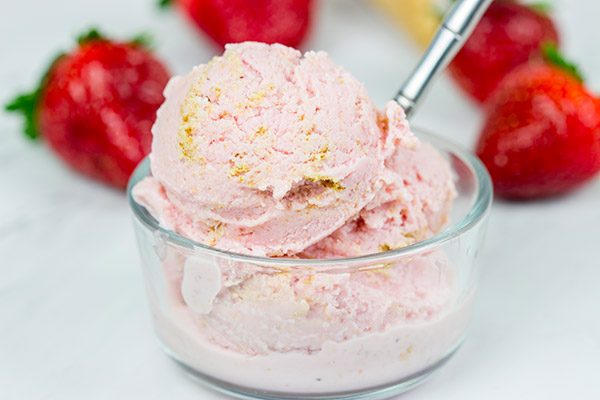Fresh strawberries blended with cream cheese and yogurt, this Strawberry Cheesecake Frozen Yogurt is the perfect treat for summer evenings on the back porch!