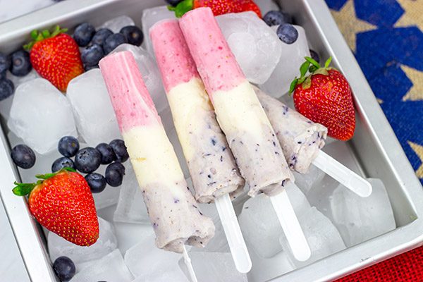 Celebrate the Fourth of July this year with these Red White and Blue Popsicles. They're the perfect cool treat on a hot summer day!