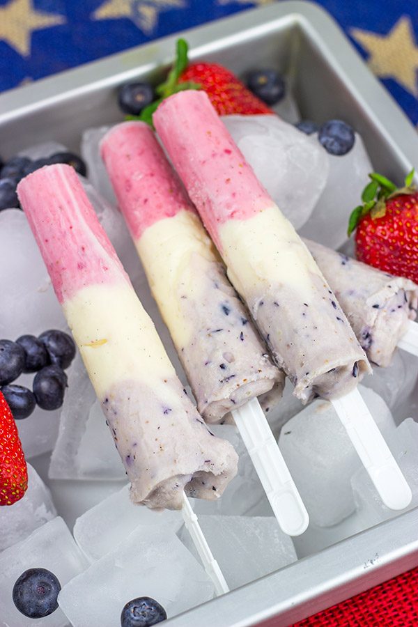Celebrate the Fourth of July this year with these Red White and Blue Popsicles. They're the perfect cool treat on a hot summer day!