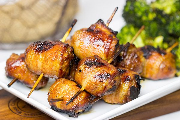 Whether in your backyard or at a picnic in the park, these Bacon-Wrapped Brats are perfect for summer grilling!