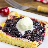 With layers of vanilla pastry cream and homemade cherry pie filling, these Vanilla Cherry Tarts make a great summer dessert!