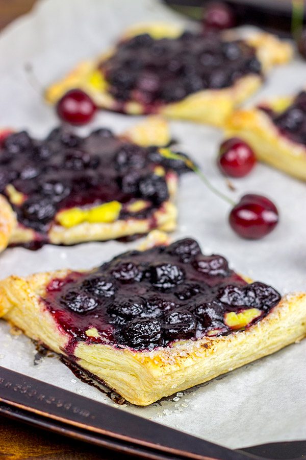 With layers of vanilla pastry cream and homemade cherry pie filling, these Vanilla Cherry Tarts make a great summer dessert!