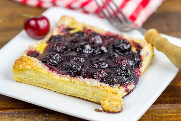 With layers of vanilla pastry cream and homemade cherry pie filling, these Vanilla Cherry Tarts make a great summer dessert!